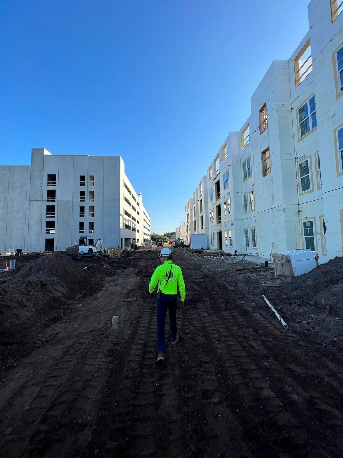 Construction professional walking through an active multifamily project